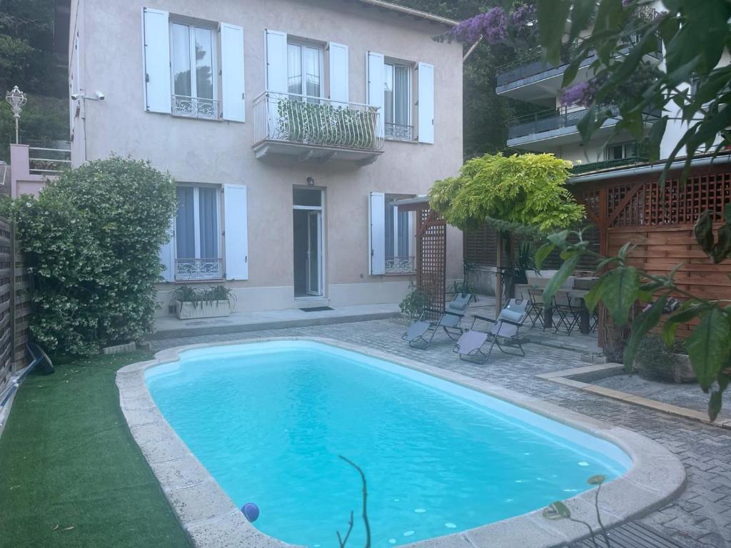 a swimming pool in front of a house at Katy in Nice