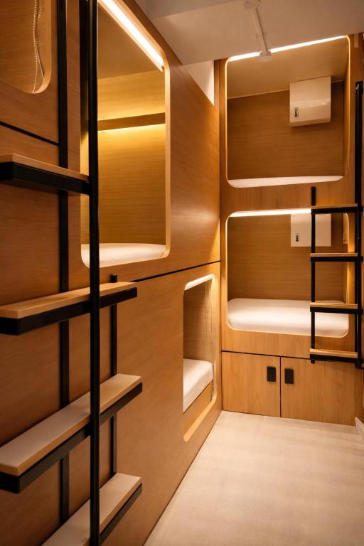 a small room with wooden cabinets and shelves at Wink at Jalan Besar in Singapore