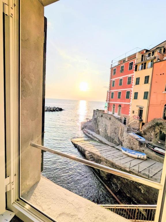 a view of the ocean from a window at Back in Tide , frontal sea view window, no AC, Pet friendly in Riomaggiore