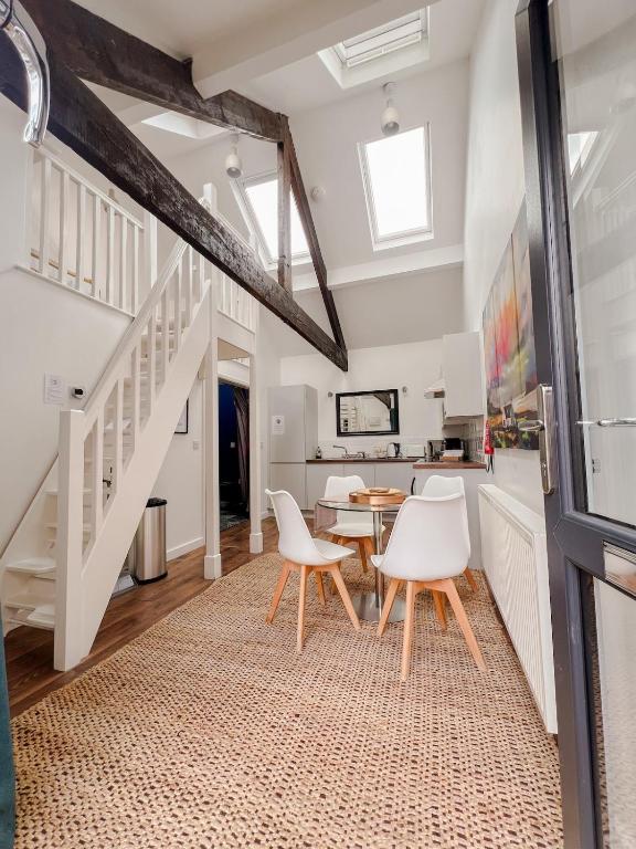 a dining room with white chairs and a table at Stylish Loft in Stockport - Free Parking - 10 min to Manchester - Flat 1 in Stockport