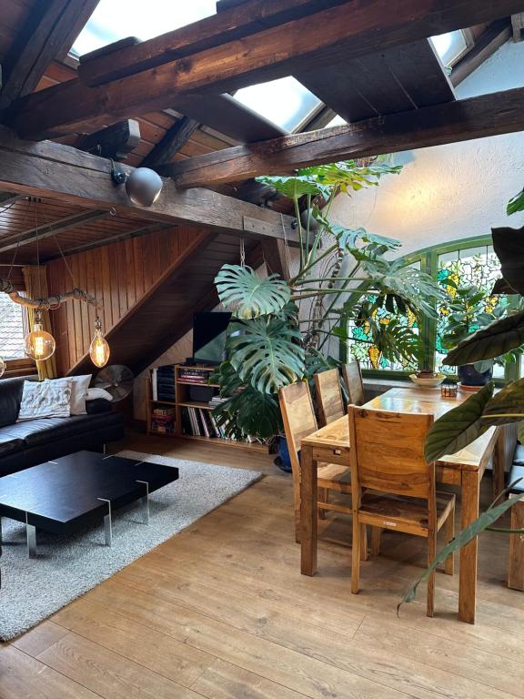 a living room with a wooden table and a couch at BLUELAND Loft in Hechendorf