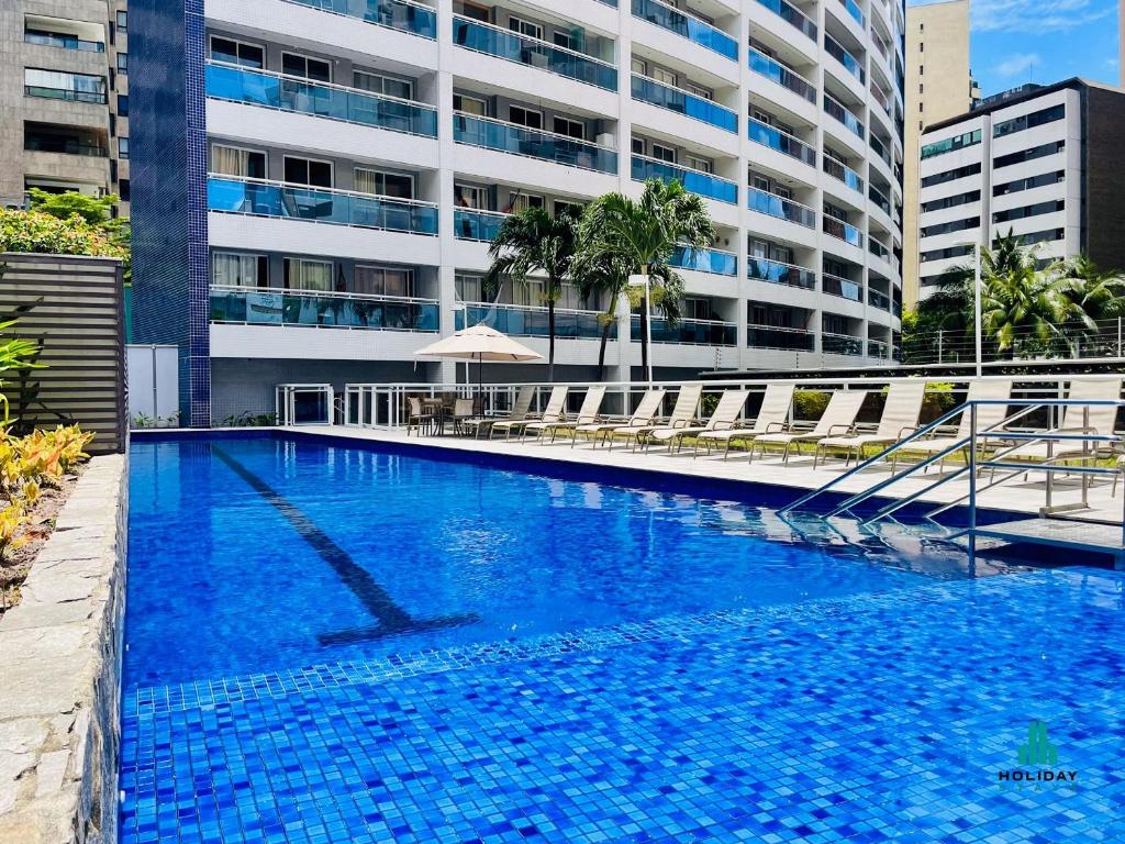 a large blue swimming pool in front of a building at My Way by Holiday Stays in Fortaleza
