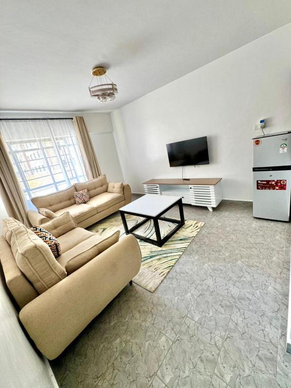 a living room with a couch and a table at brigit's home in Kisumu