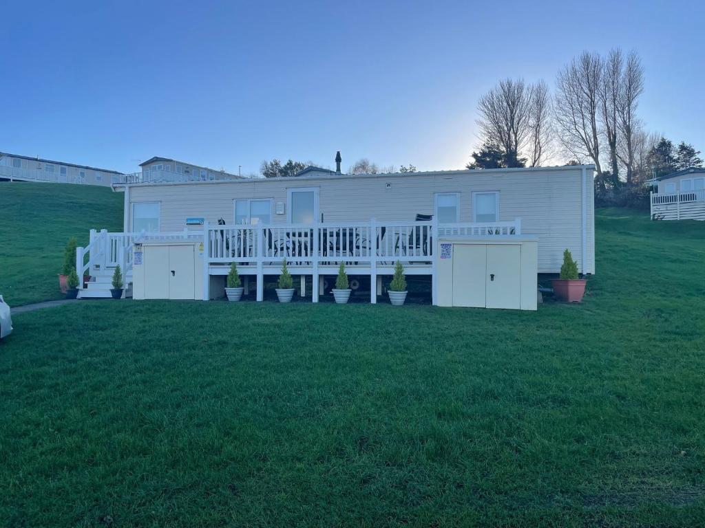 a large white house with a large yard at JSNHolidays at Craig Tara Holiday Park in Ayr