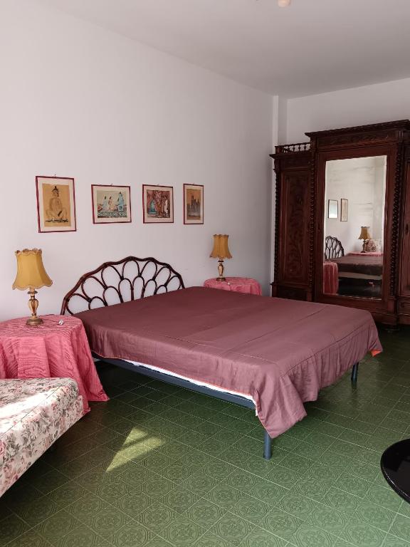 a bedroom with two beds and a mirror at Villa Rosa in Rapallo
