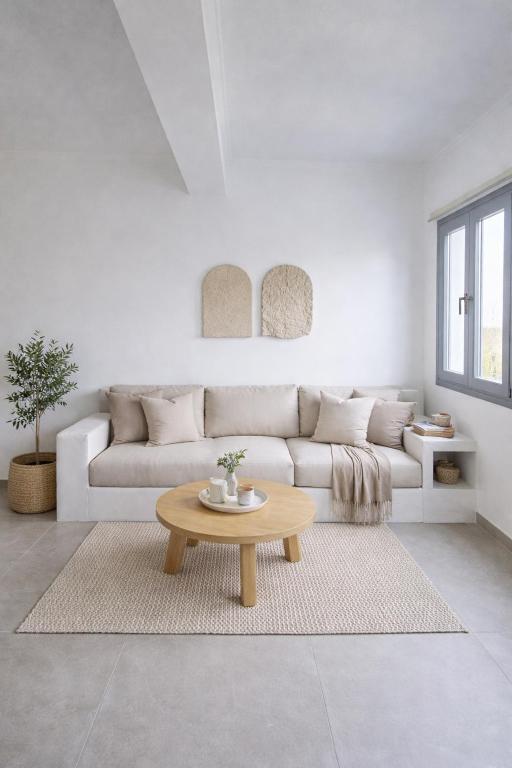 a living room with a couch and a coffee table at Atlantis Four in Éxo Goniá