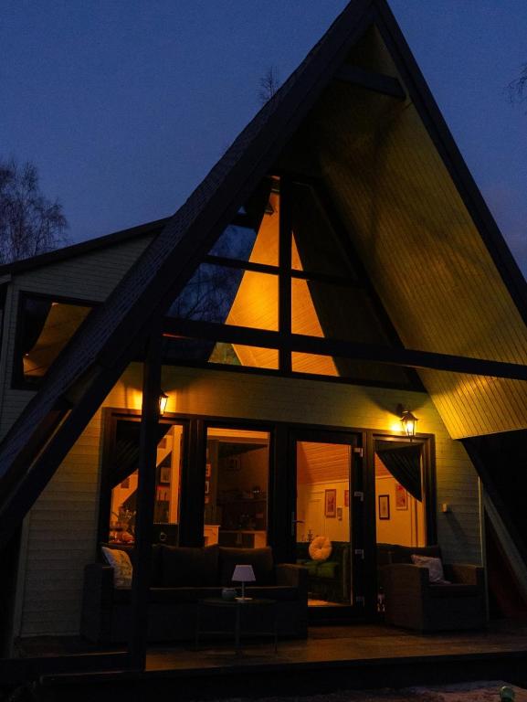 a view of a house with a large window at Acasa Straja - Green Cottage in Lupeni