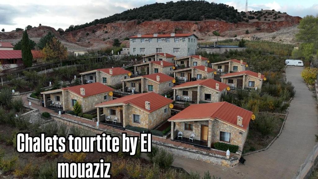 a group of houses in a city with the words chickens torture by iv monday at Chalets tourtite ifrane in Ifrane