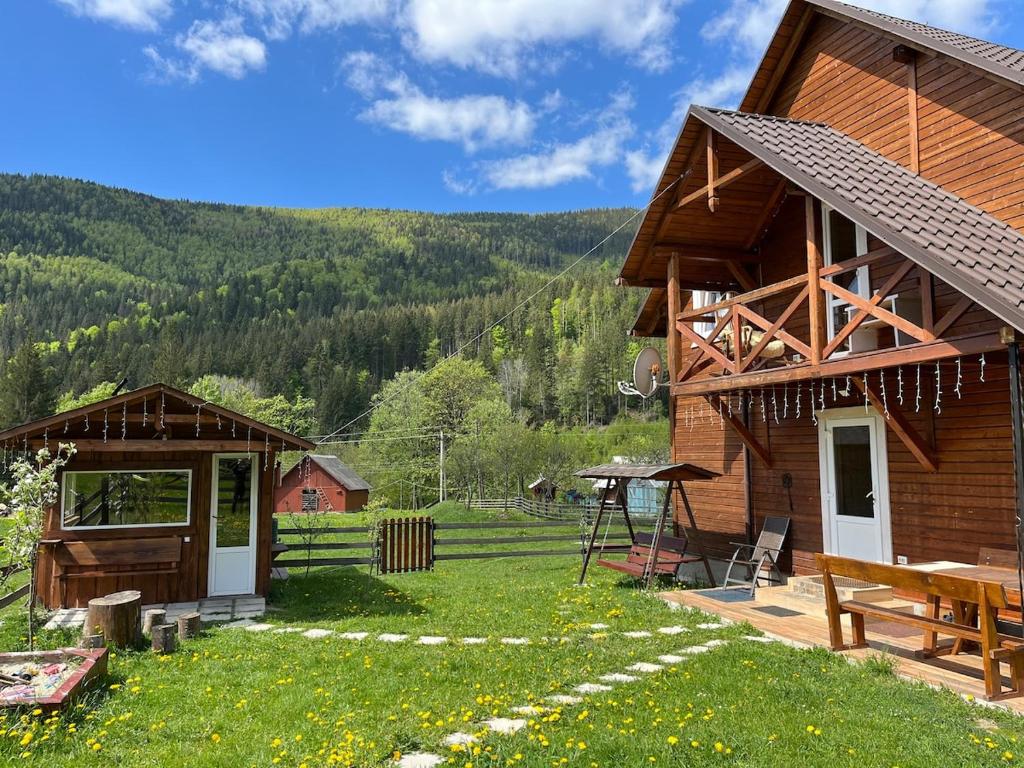 a log cabin with a view of the mountains at Наш котедж in Krivopolʼye