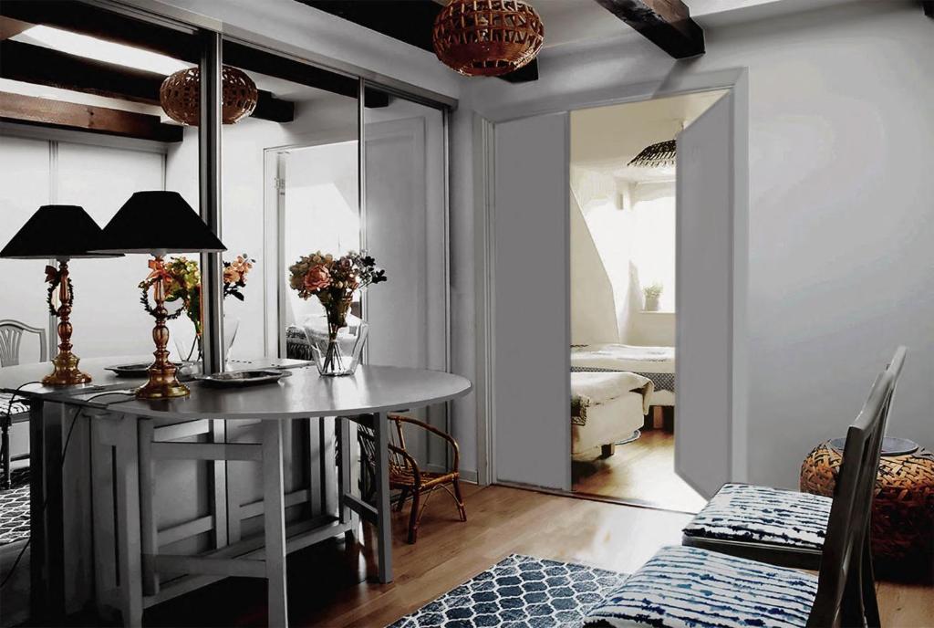 a dining room with a table and a mirror at Cozy loft living in Malmö