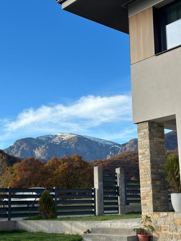 a view of a snow covered mountain from a house at Резиденция БАЛМОРА in Kalofer