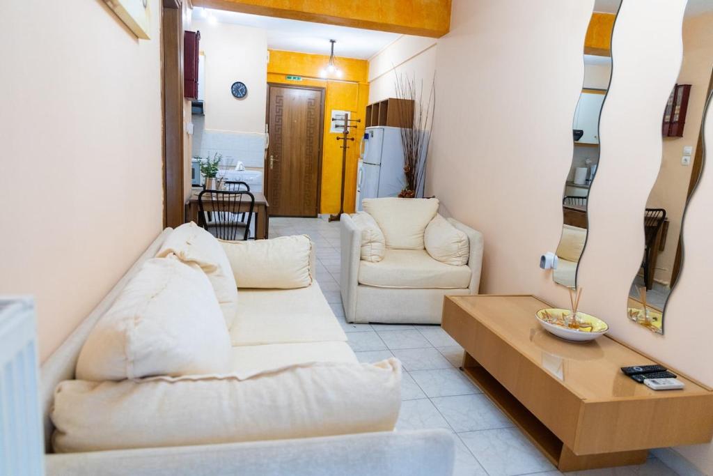 a living room with two white couches and a table at The 5th floor in Florina