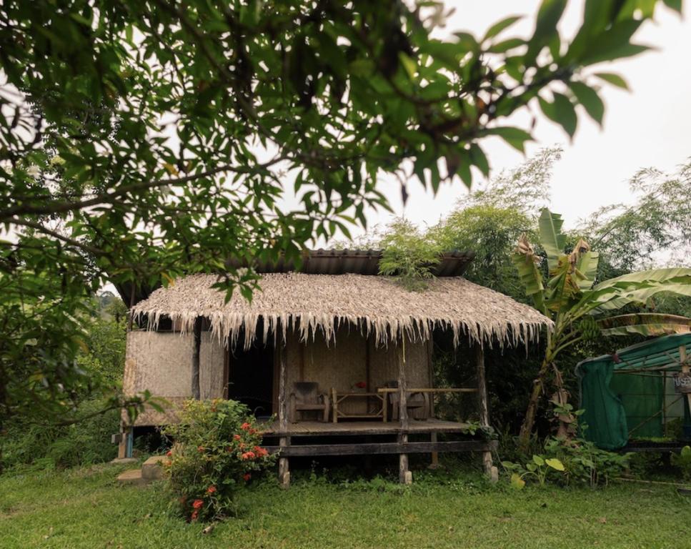 a small hut with a grass roof at LiorStays in Arambol