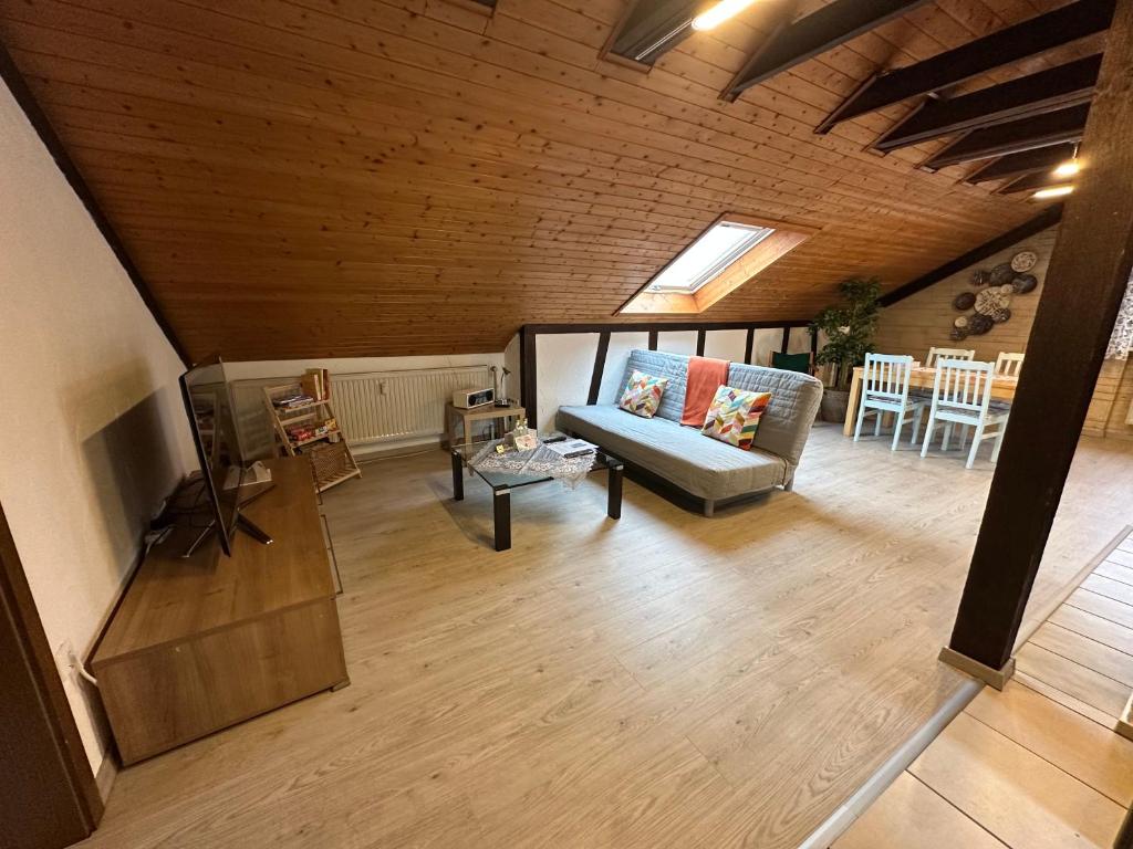 a living room with a couch and a tv at Ferienwohnung Löchgau in Löchgau
