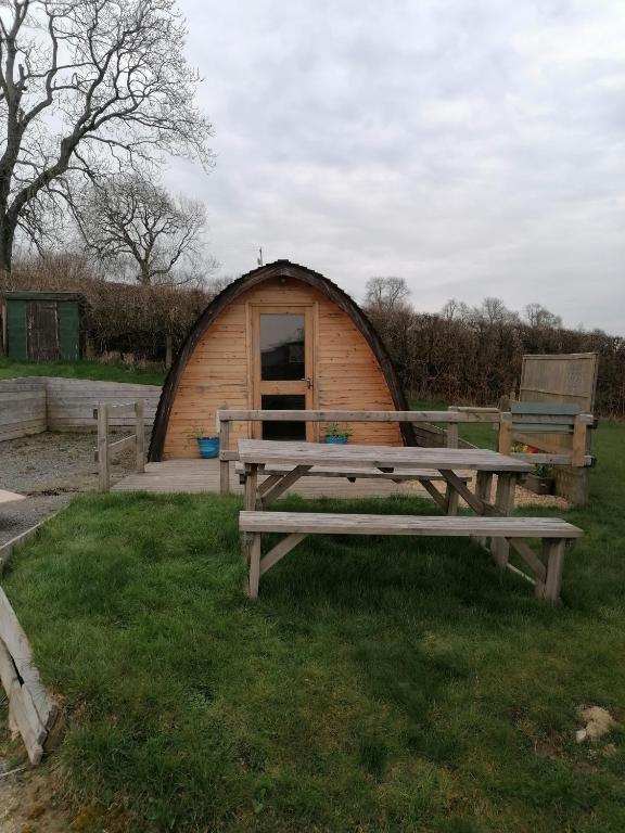 a picnic table in front of a yurt at Castle View Glamping - 2 Cefn in Llandrindod Wells
