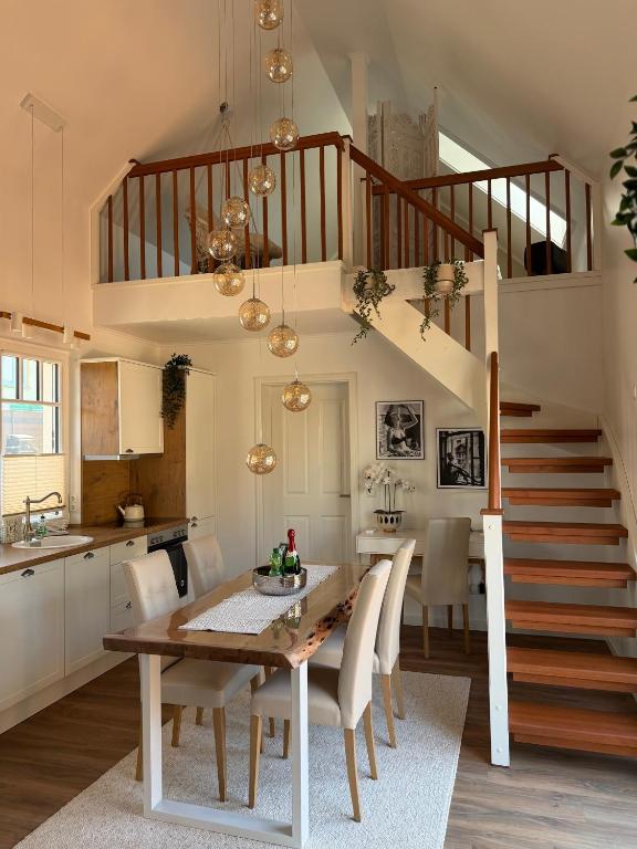 a kitchen and dining room with a table and a staircase at Haus Maria am Meer in Göhren