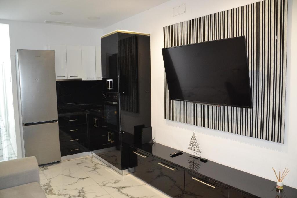 a living room with a flat screen tv on a wall at Victory in Alicante