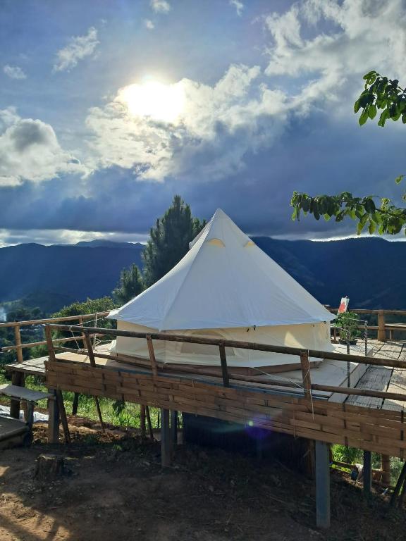 a white tent sitting on top of a wooden table at Infinite horizon nan in Ban San Khet Yao