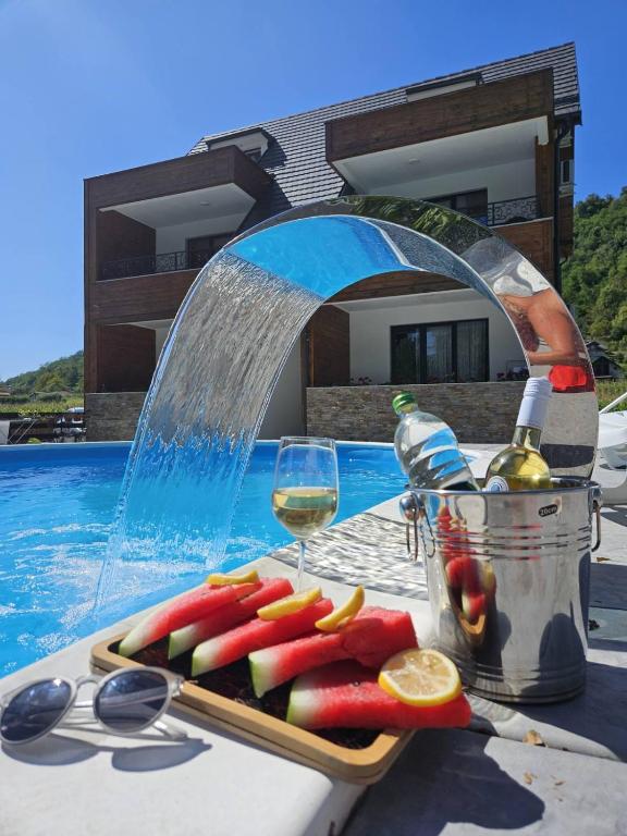 a tray of fruit on a table next to a water fountain at Drinski Zamak in Vrhpolje