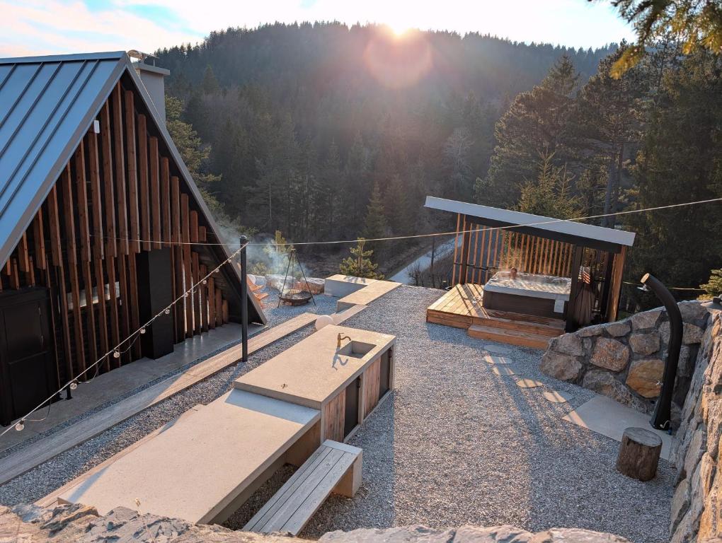 a patio with benches and a grill and a building at Pine Hill RUBY with free jacuzzi in Rakitna