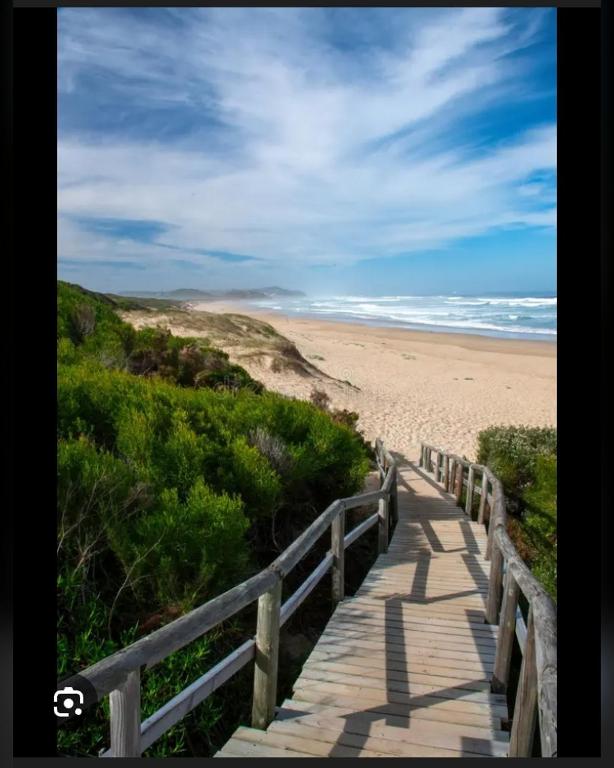 a wooden boardwalk leading to a sandy beach at The Hidden Corner in Sedgefield