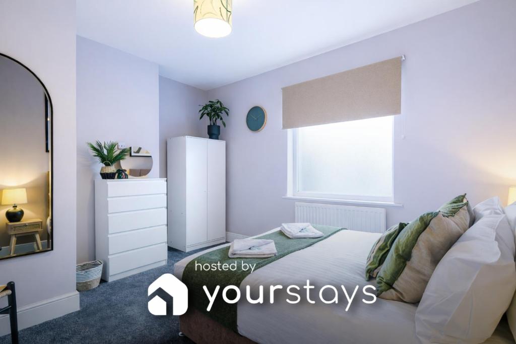 a bedroom with a bed and a dresser and a mirror at Hartshill House by YourStays in Stoke on Trent