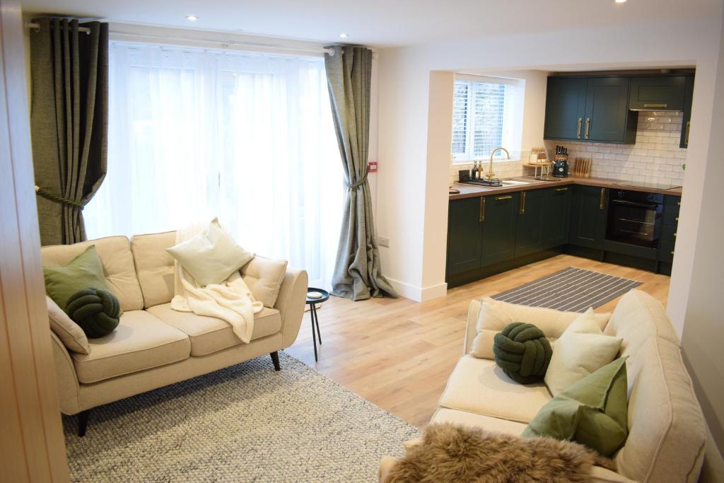 a living room with a couch and a kitchen at Westwinds View in Ludlow