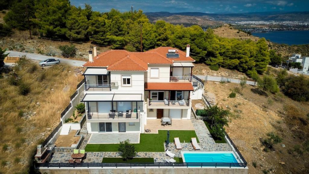 an aerial view of a house with a swimming pool at Thea Hill in Kritharia