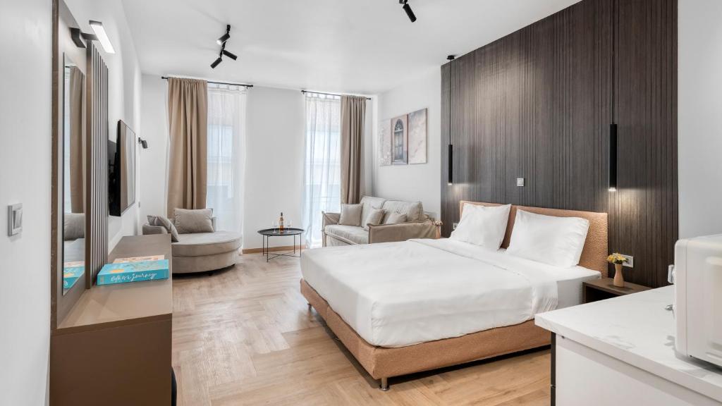 a bedroom with a bed and a living room at Athenian Heart Suites in Athens