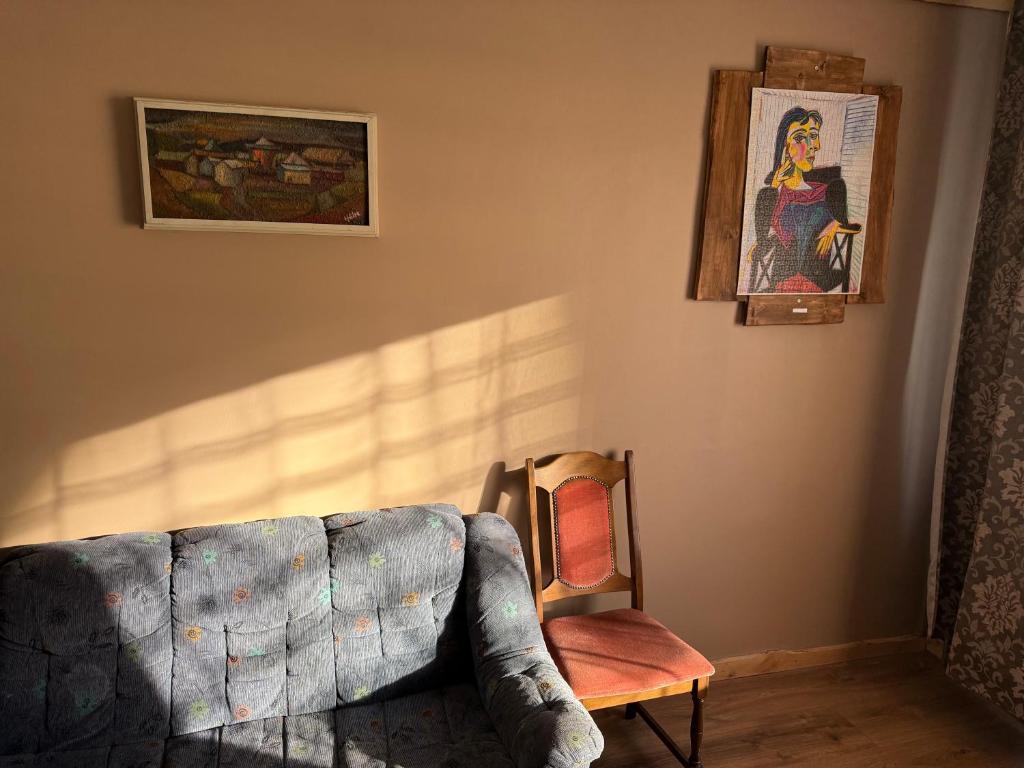 a living room with a couch and a picture on the wall at 1-bedroom 2 big beds MV64 in Tartu