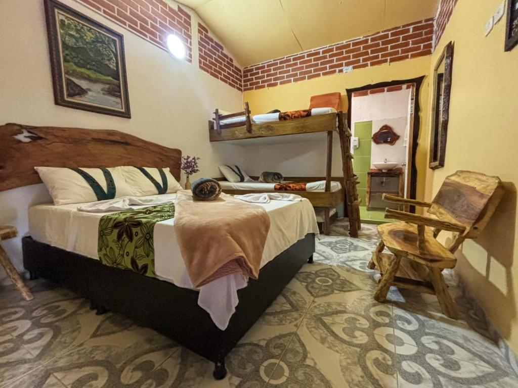 a bedroom with a bunk bed and a chair at Casa Turística Art-Vélez Salento in Salento