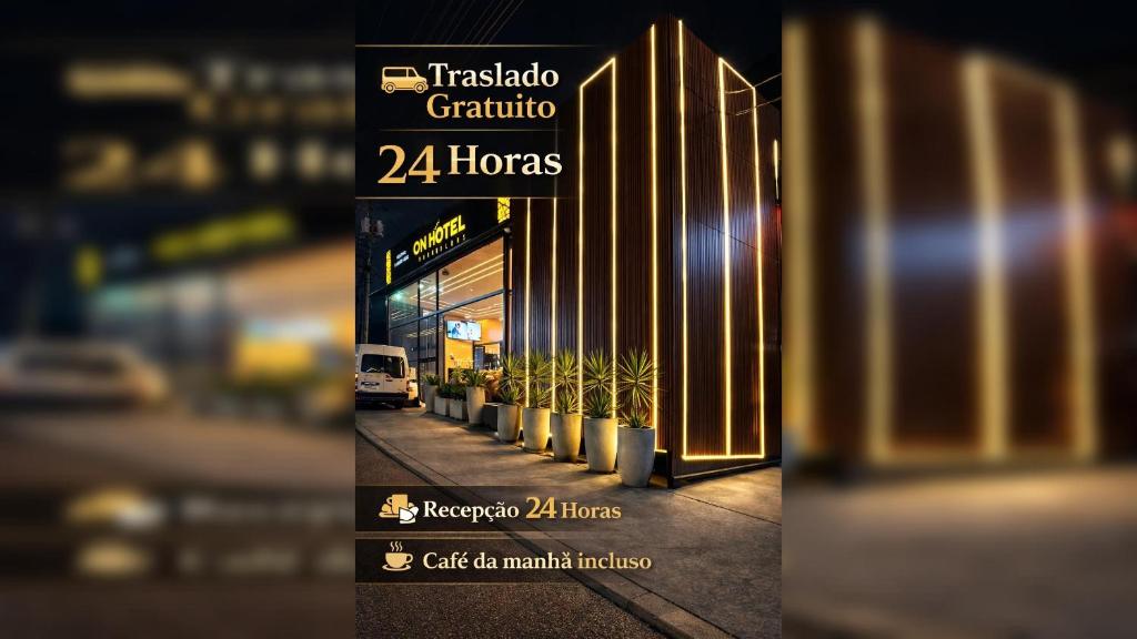 a sign in front of a building with plants at On Park Hotel e Traslado in Guarulhos