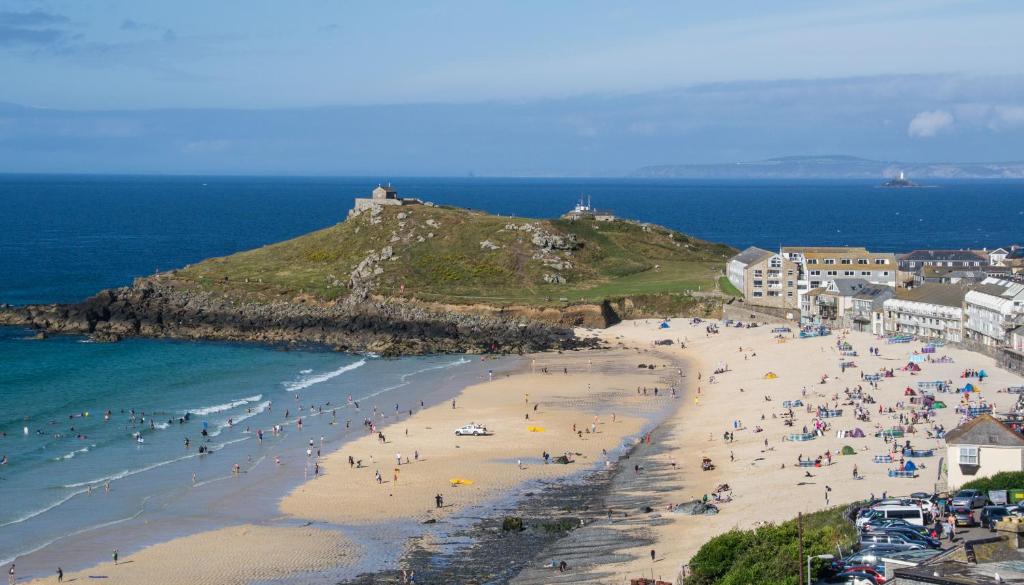 a group of people on a beach near the ocean at Atlantic Heights Guest House in St Ives