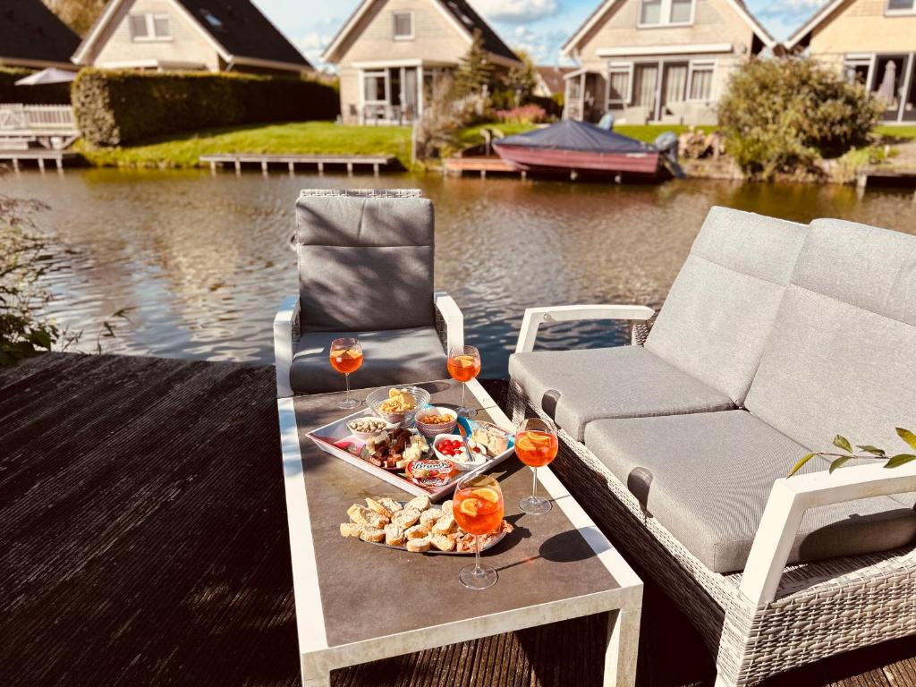 a tray of food on a table next to a chair at Vliet Huis in Medemblik