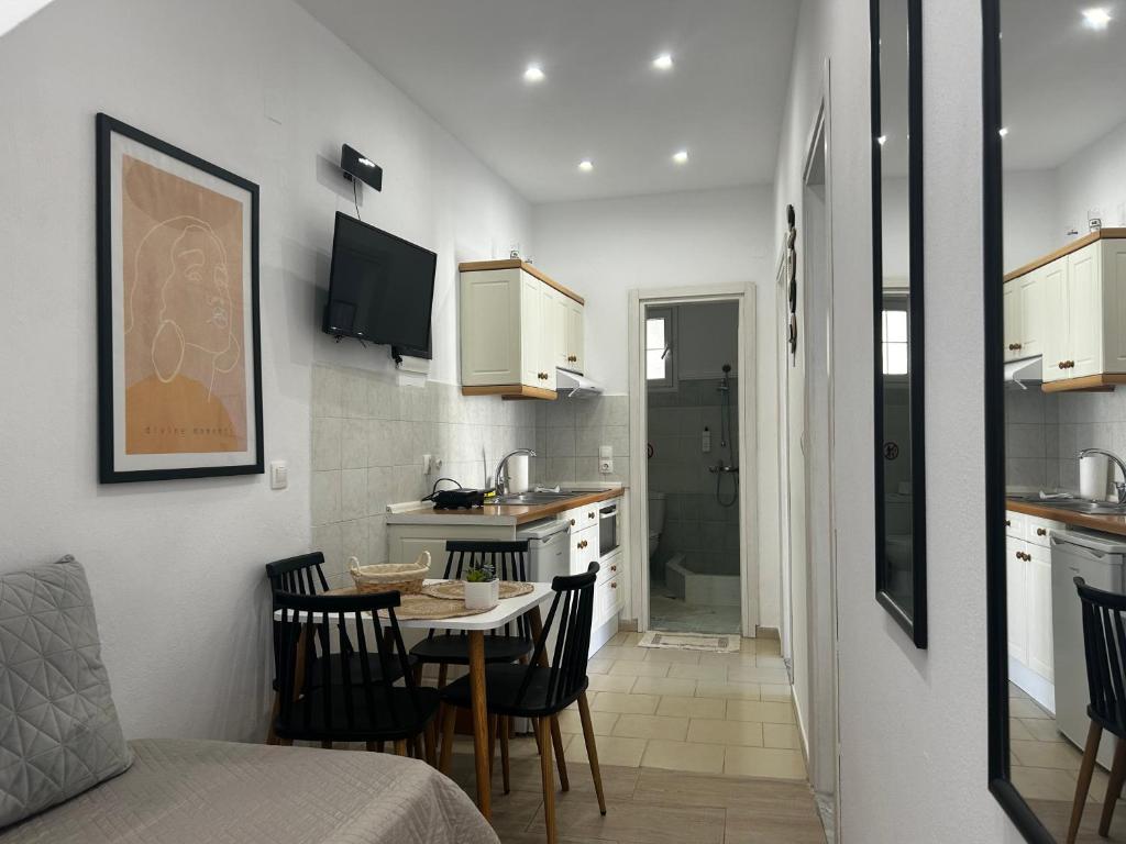 a small kitchen and dining room with a table and chairs at Happiness Apartment 7 in Sidari
