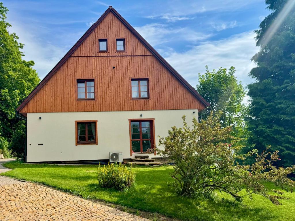 a large white house with a brown roof at Chalupa Bišík in Teplice nad Metují
