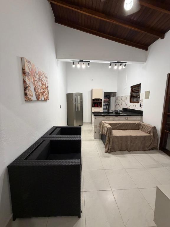 a kitchen with a sink in the middle of a room at Casa luzes Amarelas in Caraguatatuba