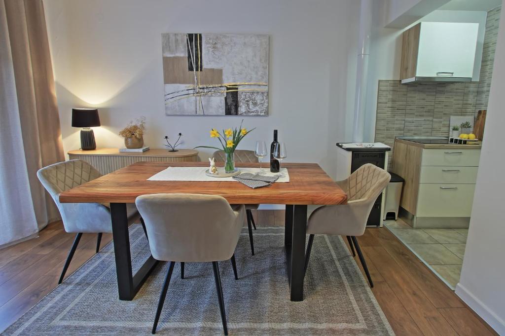 a dining room table and chairs in a kitchen at Luxury Apartment Ana in Otočac