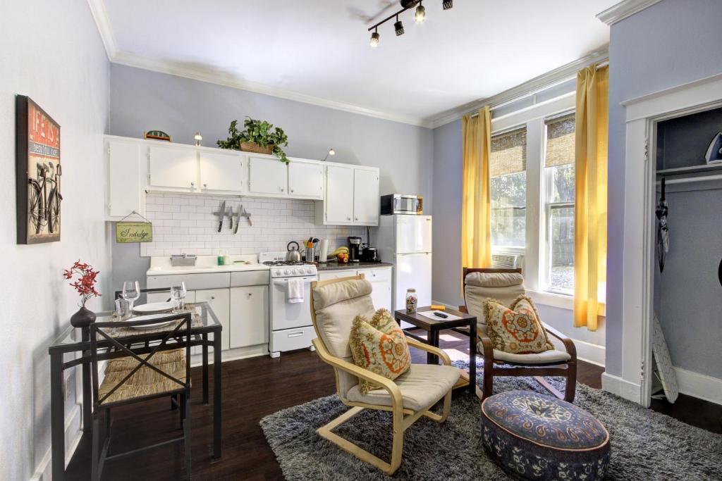 a kitchen and living room with a table and chairs at Unwind and Relax in a Historic Midtown Property in Memphis