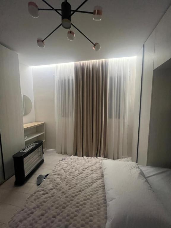 a bedroom with a bed and a ceiling fan at Fabio Home in Tirana