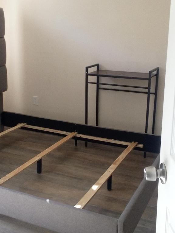 a room with a bed in a room with wooden floors at Chill Rooms in Oakland