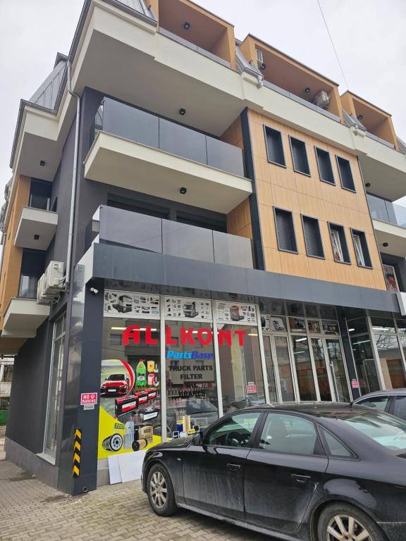a black car parked in front of a building at Dino Saraj in Skopje