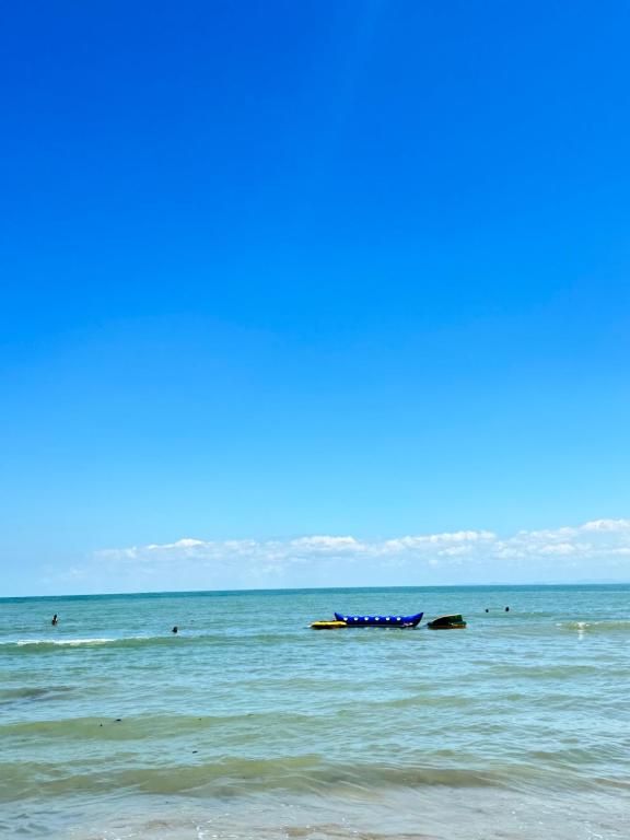 a blue boat in the water on a beach at Casa Cabaña Elena - Coveñas in San Antero