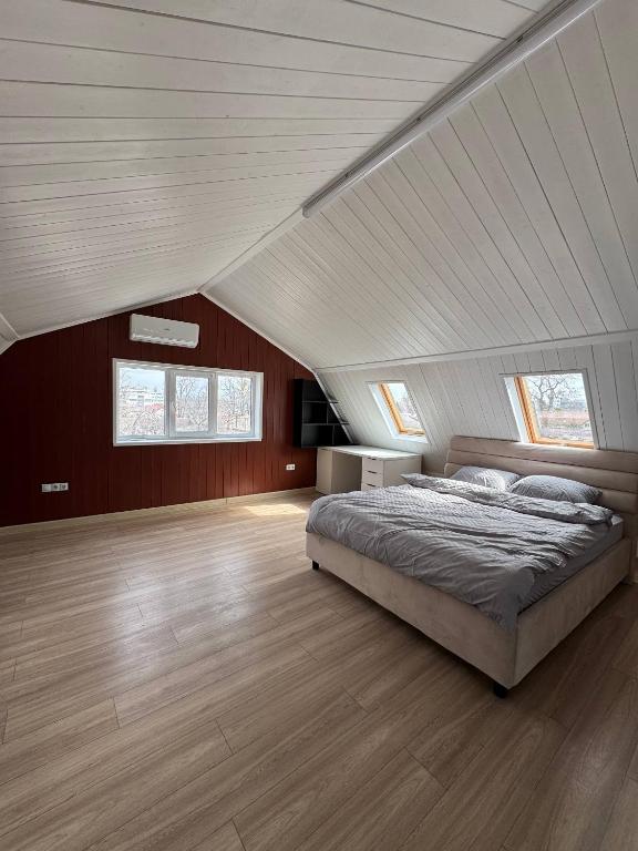 a bedroom with a large bed in a attic at Odessky Dvorik in Chişinău