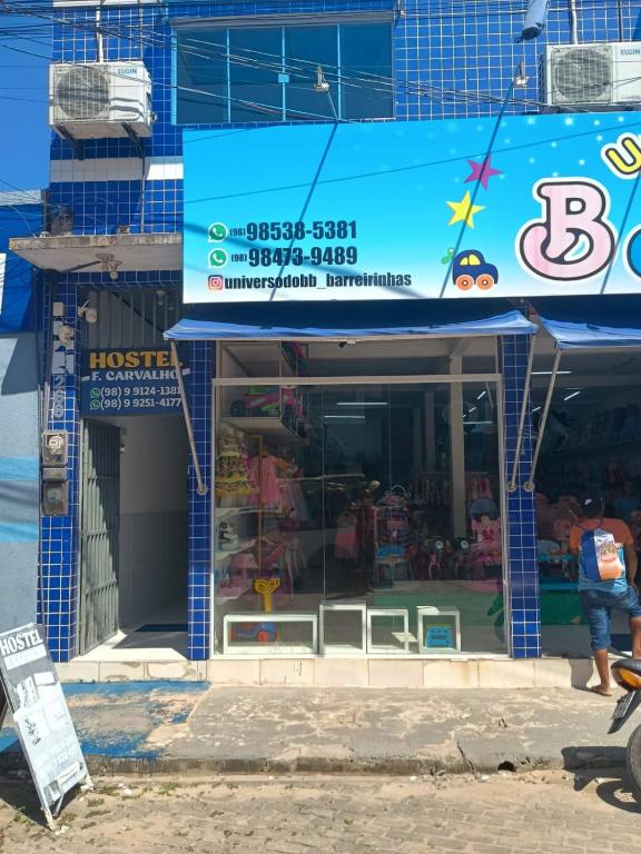 a building with a sign in front of a store at Hostel Família Carvalho in Barreirinhas
