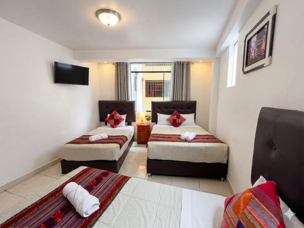 a living room with two beds and a couch at Machu Picchu Sacred Valley in Machu Picchu