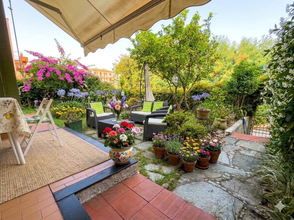 a patio with a bunch of flowers and plants at La casa di Giò in Varazze