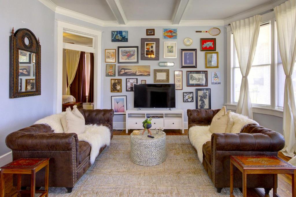a living room with two couches and a tv at Elegant Colonial with Lovely Details and Character in Memphis
