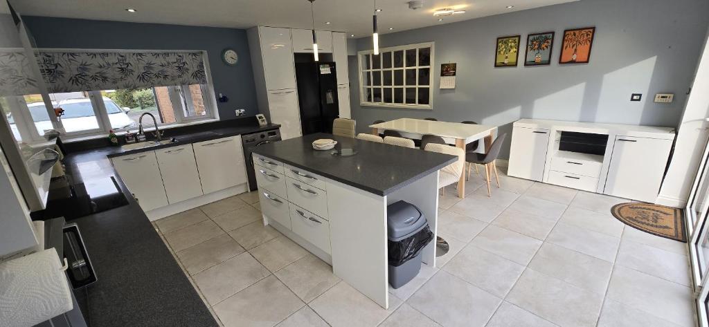 a kitchen with white cabinets and a counter top at Grace's Spacious Home in Ely in Ely