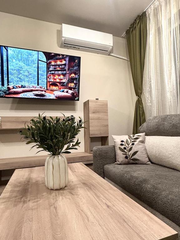 a living room with a table and a couch at Apartment Dragoman 10 in Pleven